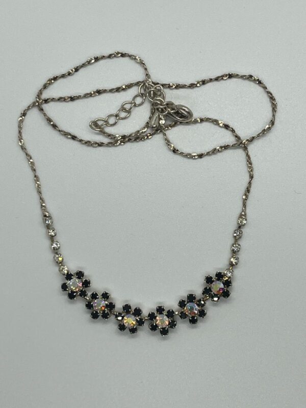 Silver chain necklace with black and crystal floral design